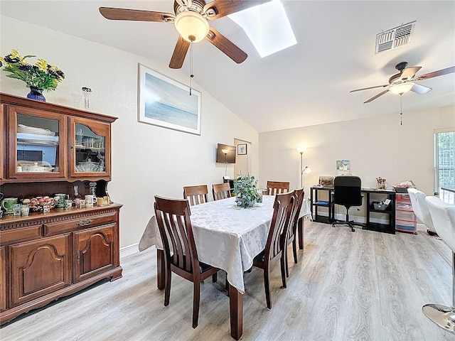 10411 Ireland St, Spring Hill, FL 34608 - dining room with a ceiling fan, light wood-type flooring, lofted ceiling, a skylight, and baseboards