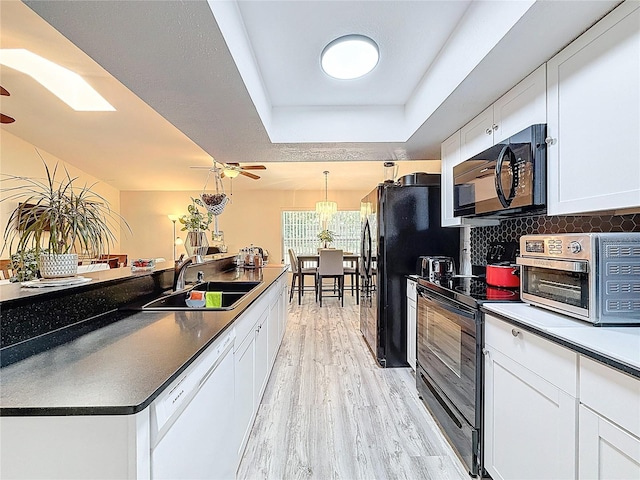 10411 Ireland St, Spring Hill, FL 34608 - kitchen with black appliances, a sink, a ceiling fan, and a raised ceiling