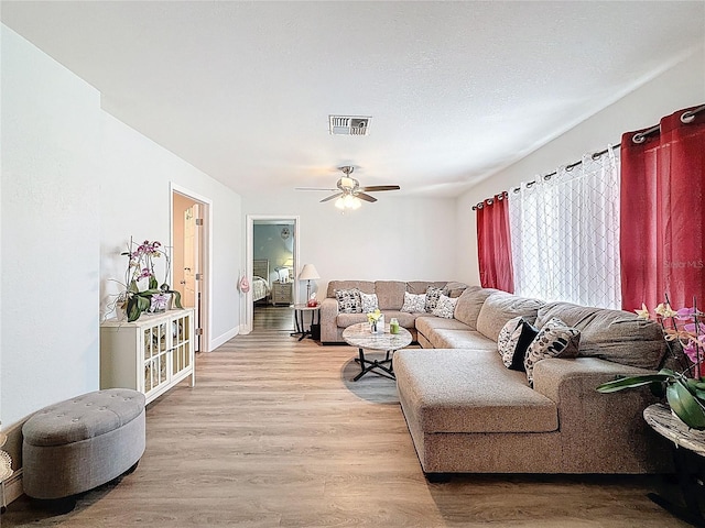 10411 Ireland St, Spring Hill, FL 34608 - living area featuring light wood-style flooring, a ceiling fan, and baseboards