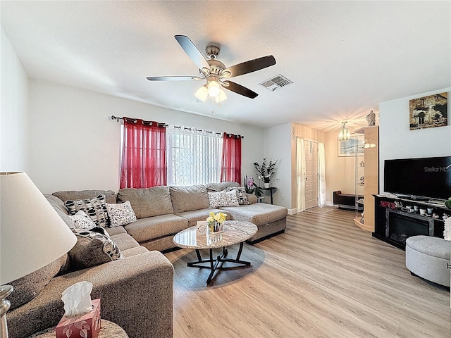 10411 Ireland St, Spring Hill, FL 34608 - living room featuring light wood-type flooring, ceiling fan, and baseboards