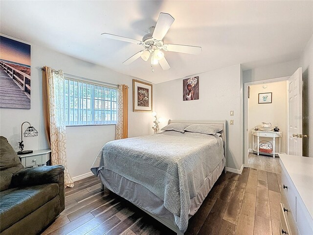 10411 Ireland St, Spring Hill, FL 34608 - bedroom featuring dark wood finished floors, a ceiling fan, and baseboards