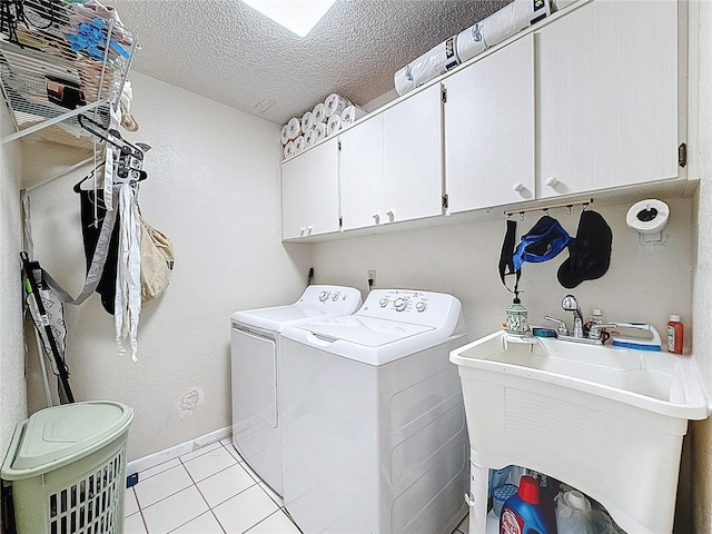 10411 Ireland St, Spring Hill, FL 34608 - washroom featuring washer and clothes dryer, cabinet space, light tile patterned floors, a textured ceiling, and baseboards
