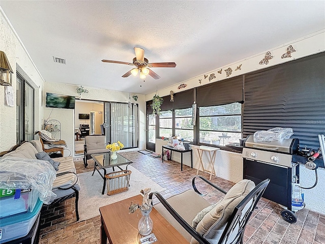 10411 Ireland St, Spring Hill, FL 34608 - living room with ceiling fan, a textured ceiling, and brick patterned floors