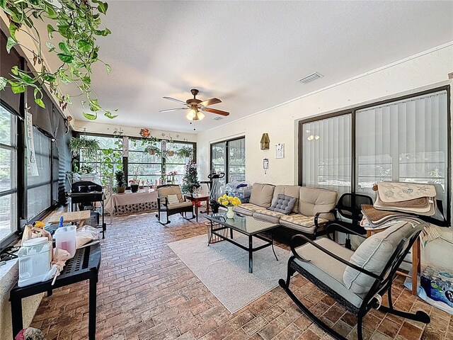 10411 Ireland St, Spring Hill, FL 34608 - living room featuring a ceiling fan, brick flooring, and a textured ceiling