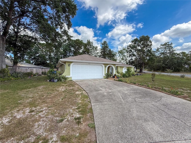 10411 Ireland St, Spring Hill, FL 34608 - view of front facade featuring a front yard, concrete driveway, an attached garage, and stucco siding