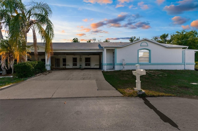 4221 San Rafael Ave, New Port Richey, FL 34655 - single story home featuring a front lawn, driveway, an attached carport, and stucco siding