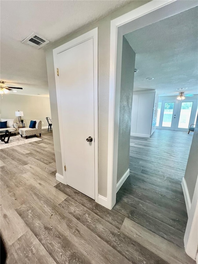 3304 Honeymoon Ln, Holiday, FL 34691 - hall featuring wood finished floors, baseboards, and a textured ceiling