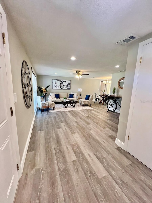 3304 Honeymoon Ln, Holiday, FL 34691 - living room featuring light wood-style flooring, ceiling fan, baseboards, and recessed lighting