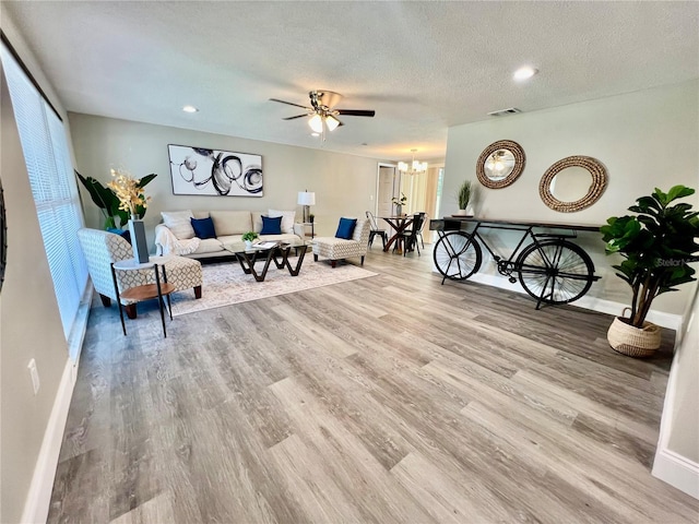3304 Honeymoon Ln, Holiday, FL 34691 - living area with wood finished floors, a chandelier, baseboards, a ceiling fan, and recessed lighting