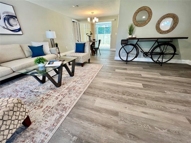 3304 Honeymoon Ln, Holiday, FL 34691 - living room featuring baseboards, a chandelier, and wood finished floors