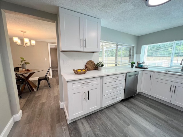 3304 Honeymoon Ln, Holiday, FL 34691 - kitchen with dishwasher, a sink, a textured ceiling, dark wood-style floors, and white cabinetry