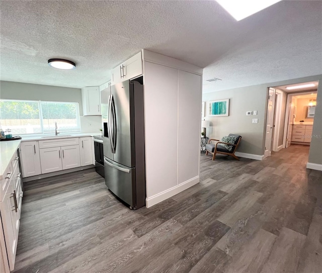 3304 Honeymoon Ln, Holiday, FL 34691 - kitchen featuring stainless steel fridge, a textured ceiling, dark wood-style flooring, a sink, and electric range oven