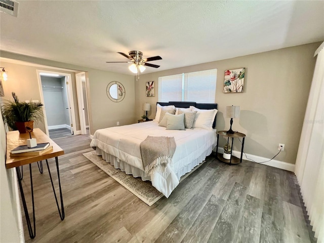 3304 Honeymoon Ln, Holiday, FL 34691 - bedroom with wood finished floors, baseboards, and ceiling fan