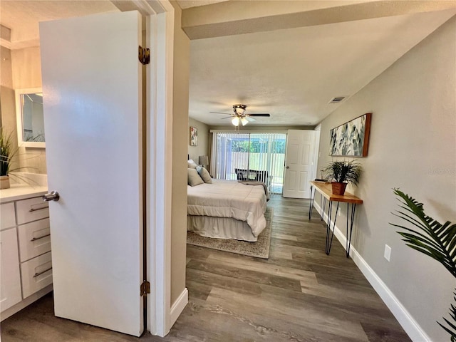 3304 Honeymoon Ln, Holiday, FL 34691 - bedroom featuring wood finished floors, baseboards, and access to exterior