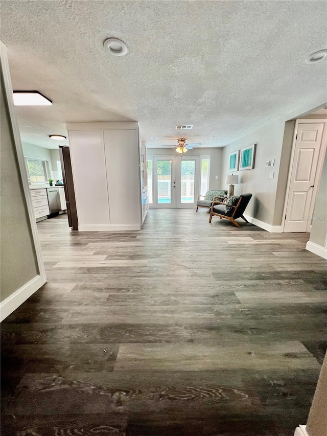 3304 Honeymoon Ln, Holiday, FL 34691 - living area featuring wood finished floors, baseboards, a textured ceiling, and healthy amount of natural light