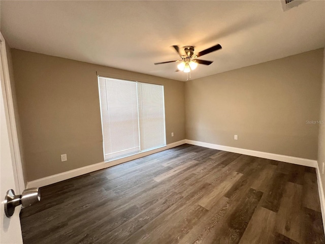 3304 Honeymoon Ln, Holiday, FL 34691 - spare room featuring baseboards, a ceiling fan, and dark wood-type flooring