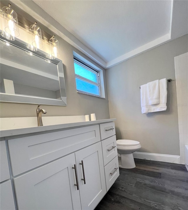 3304 Honeymoon Ln, Holiday, FL 34691 - full bath with vanity, wood finished floors, baseboards, and toilet