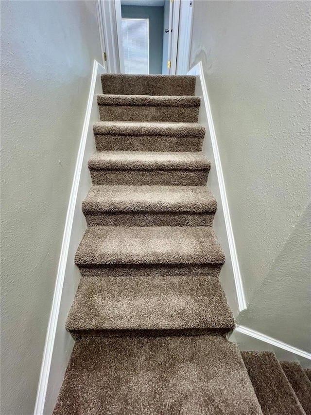 3304 Honeymoon Ln, Holiday, FL 34691 - stairs featuring a textured wall