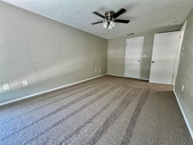 3304 Honeymoon Ln, Holiday, FL 34691 - unfurnished bedroom with carpet, baseboards, ceiling fan, and a textured ceiling