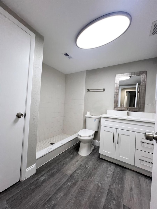 3304 Honeymoon Ln, Holiday, FL 34691 - full bath with wood finished floors, a stall shower, vanity, toilet, and baseboards