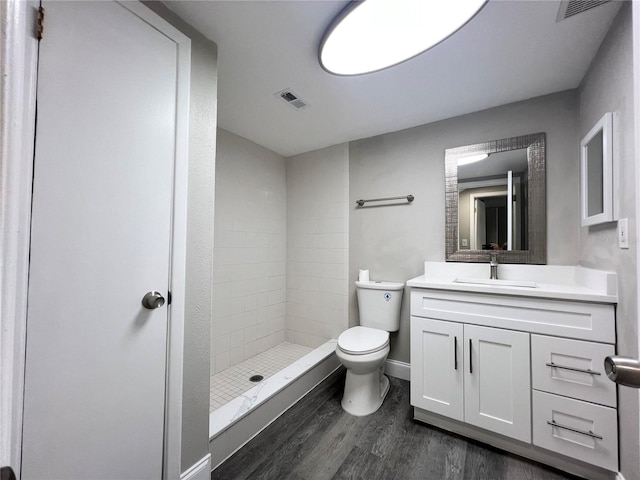 3304 Honeymoon Ln, Holiday, FL 34691 - full bathroom with wood finished floors, a shower stall, toilet, vanity, and baseboards