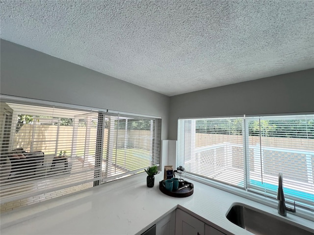 3304 Honeymoon Ln, Holiday, FL 34691 - kitchen view of a sink, a textured ceiling, and light countertops