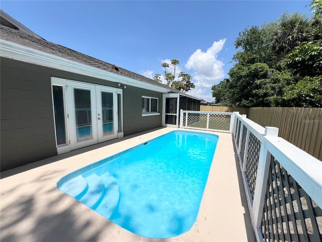 3304 Honeymoon Ln, Holiday, FL 34691 - view of swimming pool featuring a fenced backyard, french doors, a sunroom, and a patio