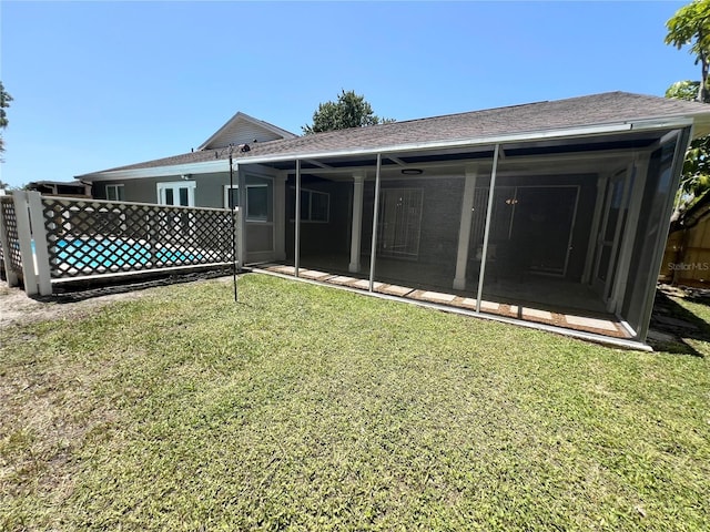 3304 Honeymoon Ln, Holiday, FL 34691 - rear view of house with roof with shingles and a sunroom
