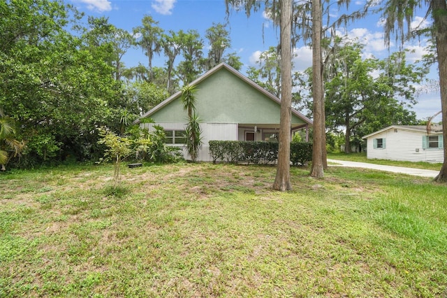 8755 Marigold Dr, New Port Richey, FL 34654 - view of side of property with a lawn