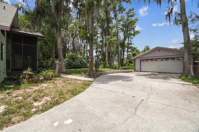 8755 Marigold Dr, New Port Richey, FL 34654 - view of yard featuring a garage and driveway
