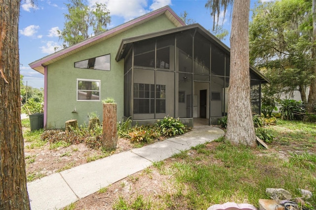 8755 Marigold Dr, New Port Richey, FL 34654 - view of front of home featuring stucco siding and a sunroom