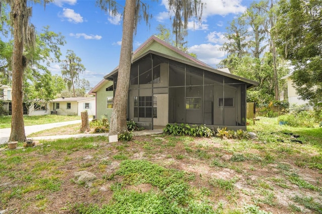 8755 Marigold Dr, New Port Richey, FL 34654 - back of house with a sunroom
