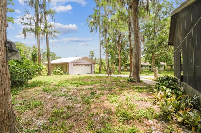 8755 Marigold Dr, New Port Richey, FL 34654 - view of yard featuring an outbuilding and a detached garage