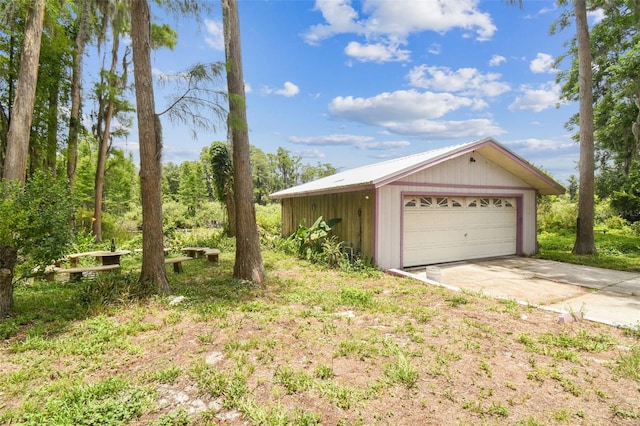 8755 Marigold Dr, New Port Richey, FL 34654 - view of home's exterior with an outbuilding and a garage