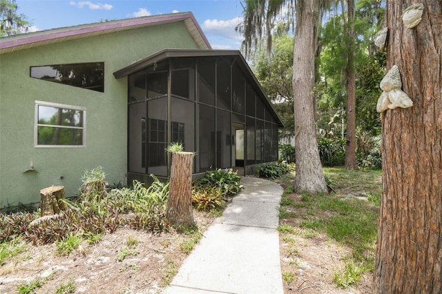 8755 Marigold Dr, New Port Richey, FL 34654 - view of front facade featuring a sunroom and stucco siding