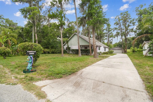 8755 Marigold Dr, New Port Richey, FL 34654 - view of side of home featuring an outbuilding, a yard, a detached garage, and view of scattered trees