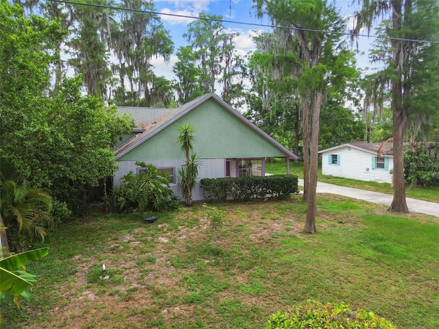 8755 Marigold Dr, New Port Richey, FL 34654 - view of home's exterior with a lawn