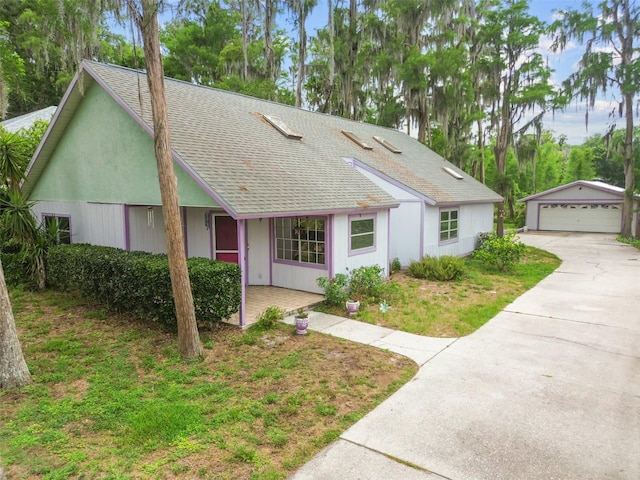 8755 Marigold Dr, New Port Richey, FL 34654 - single story home featuring a shingled roof, an outdoor structure, and a detached garage