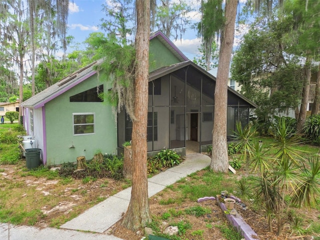 8755 Marigold Dr, New Port Richey, FL 34654 - view of front of house with a sunroom and stucco siding