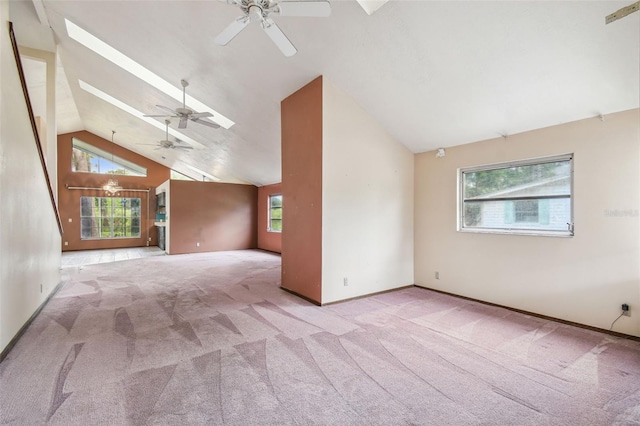 8755 Marigold Dr, New Port Richey, FL 34654 - unfurnished living room with ceiling fan, carpet flooring, high vaulted ceiling, healthy amount of natural light, and baseboards