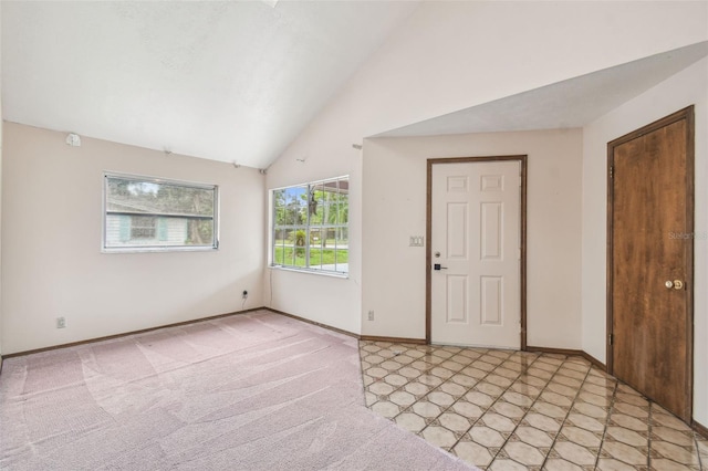 8755 Marigold Dr, New Port Richey, FL 34654 - entryway featuring baseboards, high vaulted ceiling, and light colored carpet