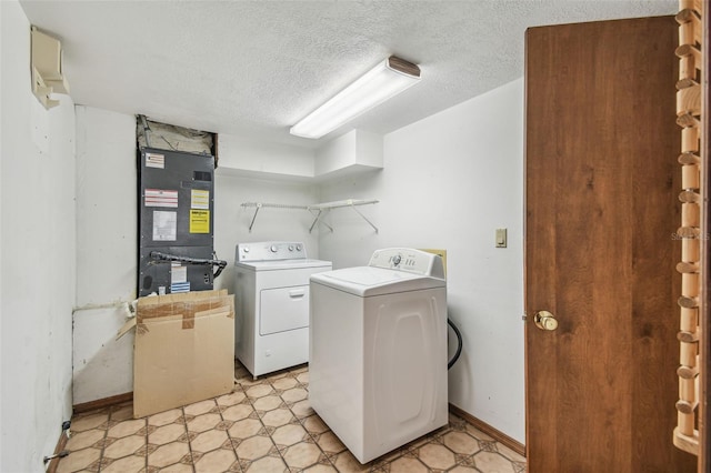 8755 Marigold Dr, New Port Richey, FL 34654 - laundry room with washing machine and dryer, heating unit, light floors, and a textured ceiling