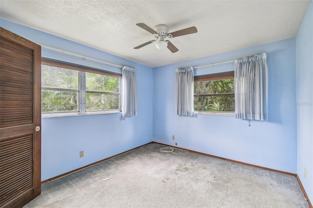 8755 Marigold Dr, New Port Richey, FL 34654 - unfurnished room with carpet floors, a ceiling fan, and baseboards