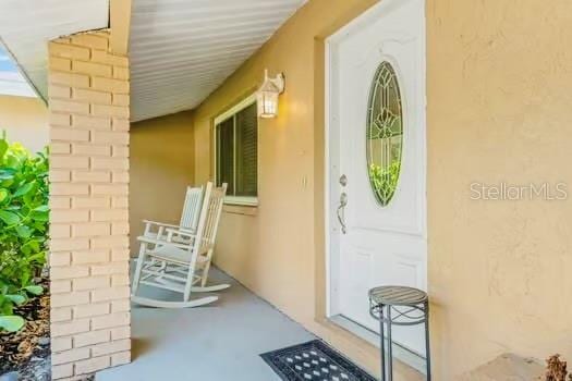 6656 Pinecrest Ln N, Pinellas Park, FL 33781 - entrance to property with stucco siding and covered porch