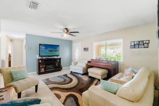 6656 Pinecrest Ln N, Pinellas Park, FL 33781 - living area with a ceiling fan and baseboards