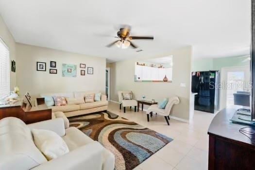 6656 Pinecrest Ln N, Pinellas Park, FL 33781 - tiled living room featuring ceiling fan and plenty of natural light