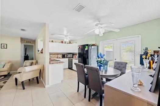 6656 Pinecrest Ln N, Pinellas Park, FL 33781 - dining space featuring french doors, ceiling fan, and light tile patterned floors
