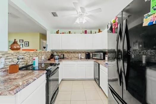 6656 Pinecrest Ln N, Pinellas Park, FL 33781 - kitchen featuring black appliances, tasteful backsplash, a ceiling fan, and white cabinetry