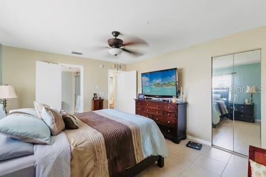 6656 Pinecrest Ln N, Pinellas Park, FL 33781 - bedroom featuring a closet, light tile patterned floors, a ceiling fan, and baseboards