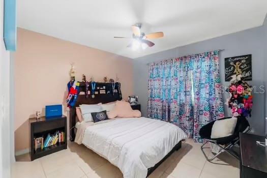 6656 Pinecrest Ln N, Pinellas Park, FL 33781 - tiled bedroom with ceiling fan